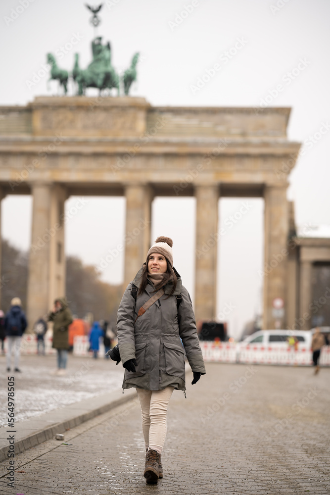 Young tourist with the Brandenburg Gate in the background in Berlin, Germany - tourism concept