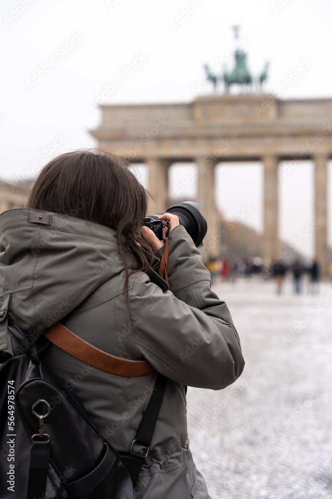 Young female photographer taking a picture of a the Brandenbourg Gate in Berlin. Young female photographer taking a picture of a the Brandenbourg Gate in Berlin.