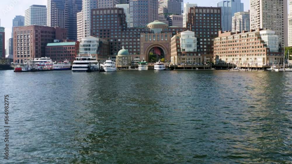 Low drone shot approaching Boston skyline from Boston harbor