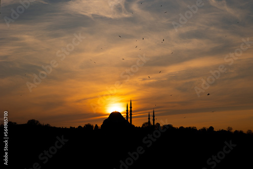 Suleymaniye Mosque and sun at sunset. Dramatic view of Istanbul at sunset