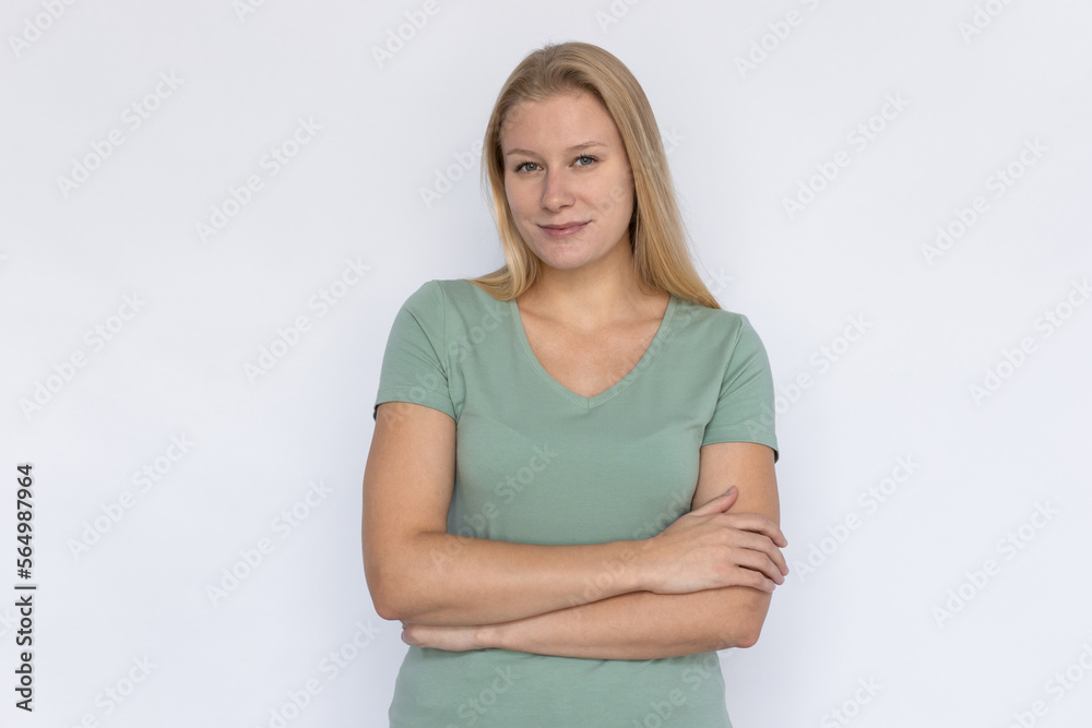 Confident woman with arms crossed. Young female model looking at camera with smile. Portrait, studio shot, confidence concept Confident woman with arms crossed. Young female model looking at camera with smile. Portrait, studio shot, confidence concept