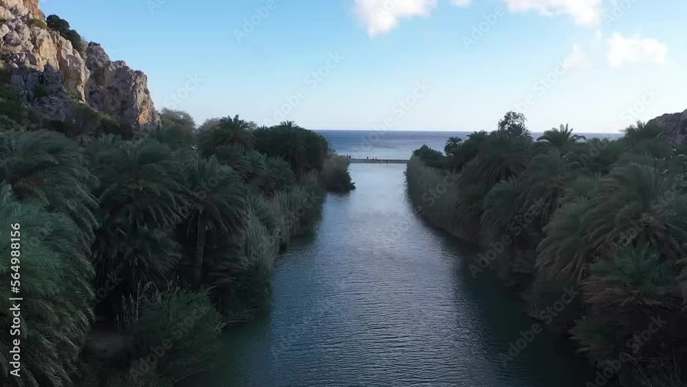 The drone captures the serene beauty of a river winding its way through ...