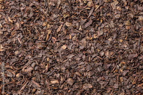 Tea, dried leaves brown, background uniform texture, bunch in bulk, close-up macro top view