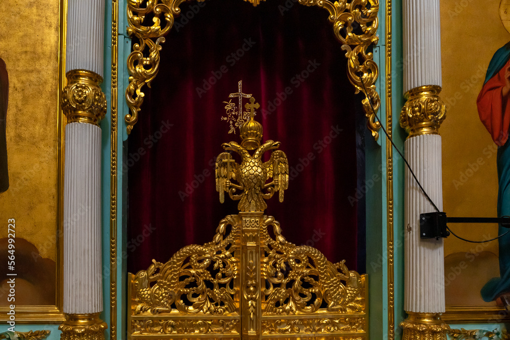 The gilded Russian double-headed eagle on the door to the altar in the Monastery Deir Hijleh - Monastery of Gerasim of Jordan, in the Palestinian Authority, in Israel
