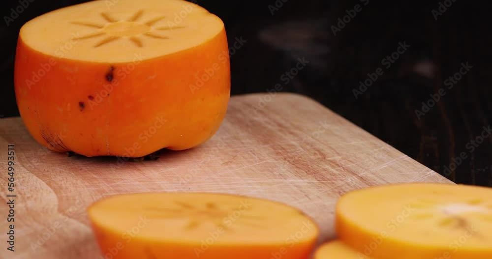 Half-cut ripe and sweet persimmon, details of the pulp of ripe persimmon Half-cut ripe and sweet persimmon, details of the pulp of ripe persimmon