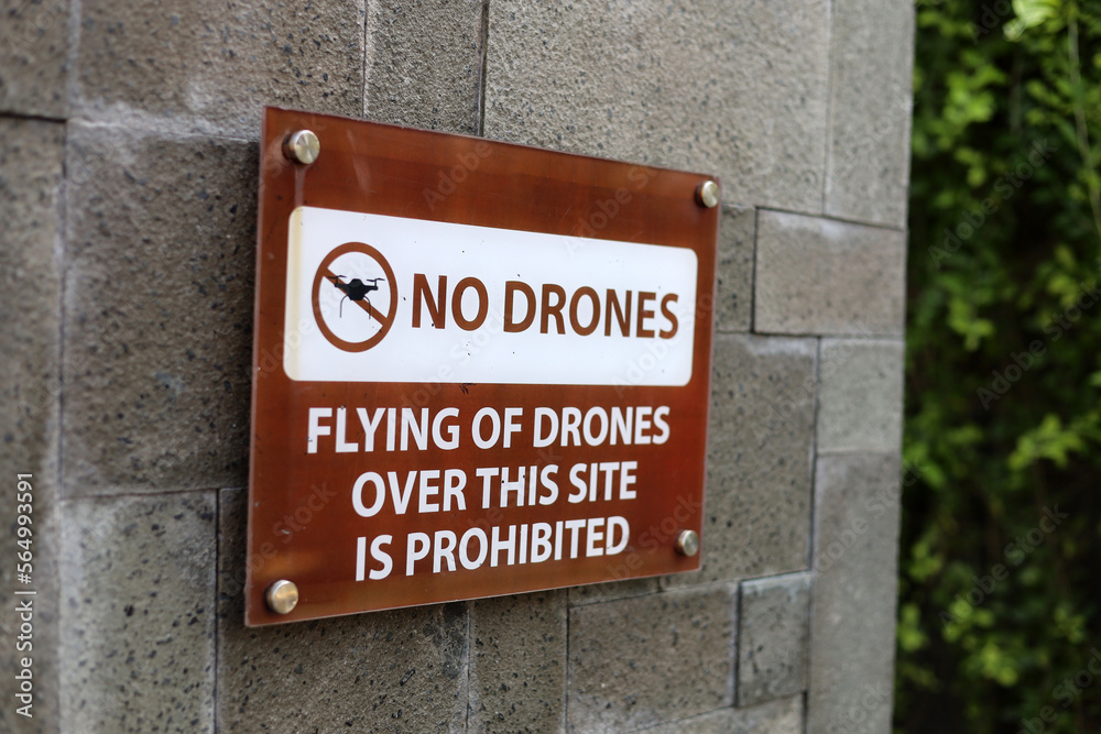 No drone zone sign not allowing flying of quad copter around tall building No drone zone sign not allowing flying of quad copter around tall building