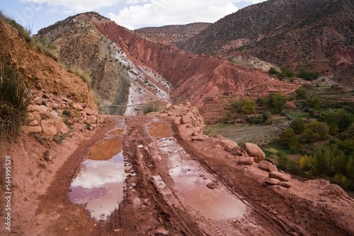 Water puddles form in the ruts of a muddy dirt road at Sebt Ait Bou Wlli in the M'Goun Massif, Central High Atlas, Morocco. photo