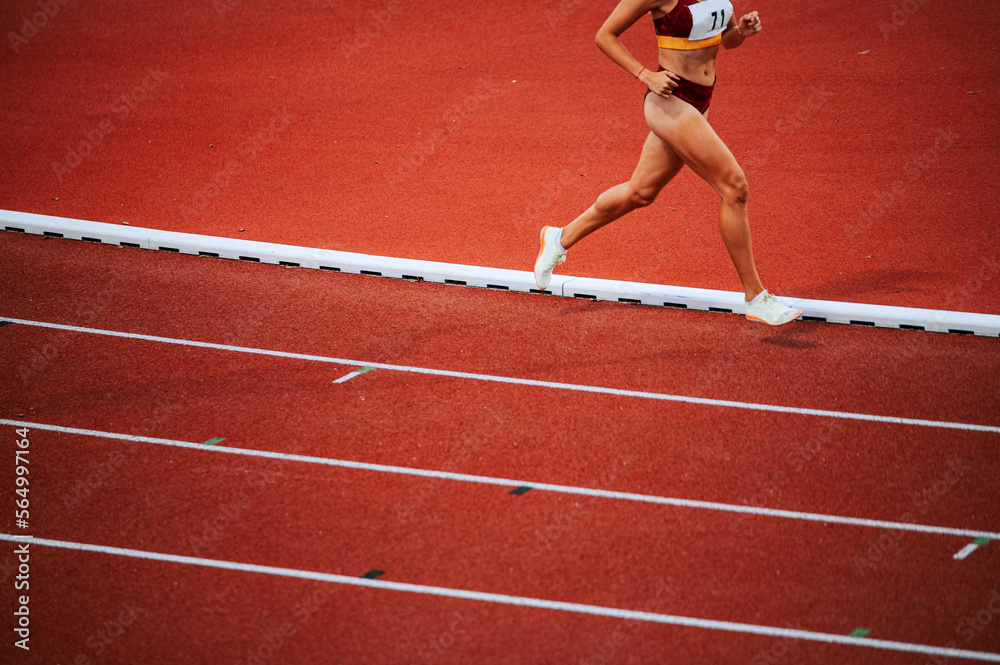 Determined female athlete legs pushing through a 1500m race on track, showcasing their athleticism and physical fitness