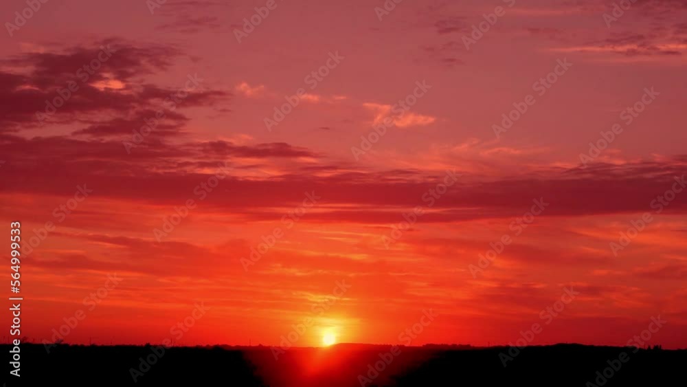 Red Fiery Sunset Sky Clouds Sun Field Time Lapse. Colorful Red Sky at Sunset. Beautiful Dramatic Fiery Sunset. The Sun Sets Beyond the Horizon in the Field, Timelapse.