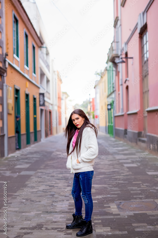 Naklejka premium Beauty happy Non-binary woman in colorful wall looking at camera