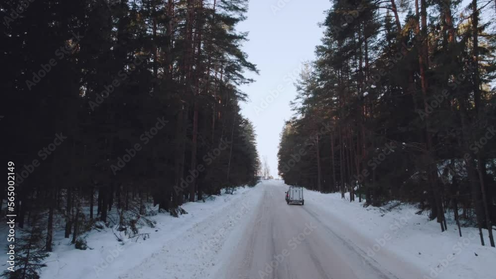 Car traveler in winter, aerial photography of a car with a trailer in winter, aerial photography of a camper in winter
