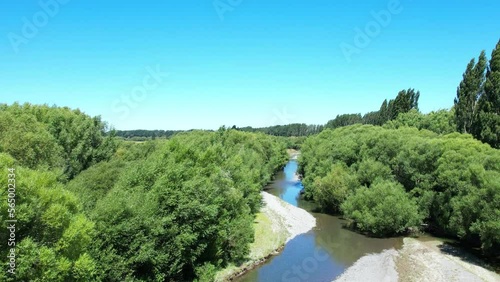 Aerial climb revealing path of Selwyn River at Chamberlains Ford in summertime (New Zealand) photo