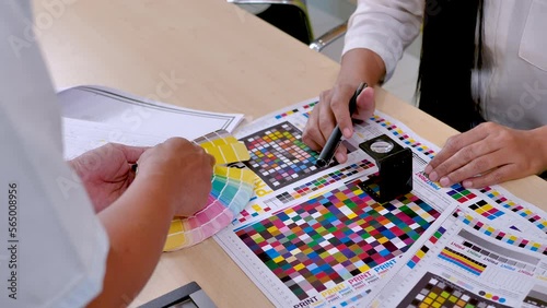 workers checking print quality of media graphics proof print and matching color tone in printing industry. 4K