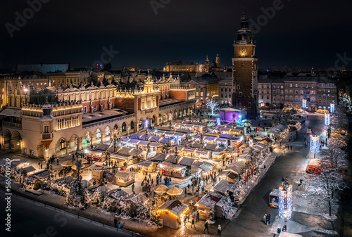 Christmas stalls with snow at night on the Main Market Square in Krakow, Poland