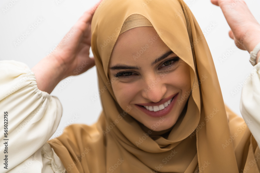 Portrait of young muslim woman wearing hijab on isolated white background