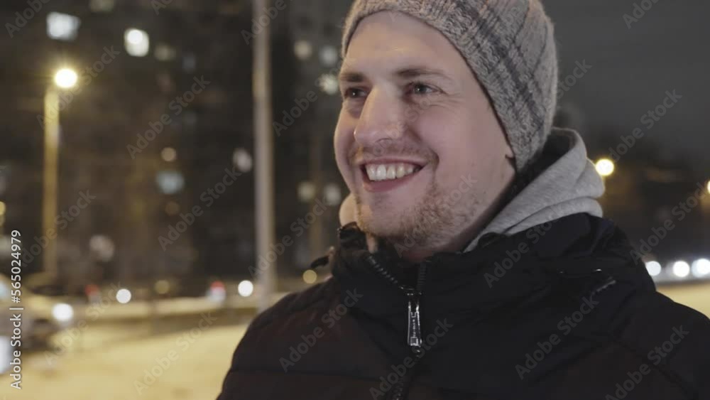 Wide smile on face of happy traveler on a cold winter evening outdoors Wide smile on face of happy traveler on a cold winter evening outdoors