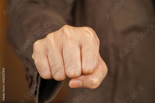 Man in suit showing anger with his right fist ready to fight ,Businessman throwing punch