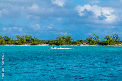 A view towards the tree lined coastline on the island of Eleuthera, Bahamas on a bright sunny day
