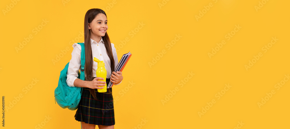 happy kid with backpack and workbooks going to drink water bottle in uniform full length, schoolgirl. Banner of school girl student. Schoolgirl pupil portrait with copy space. happy kid with backpack and workbooks going to drink water bottle in uniform full length, schoolgirl. Banner of school girl student. Schoolgirl pupil portrait with copy space.