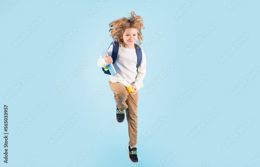 Kid jump and enjoy school. Full length body of little school kid jumping having fun isolated blue background. Crazy school boy jump. Kid jump and enjoy school. Full length body of little school kid jumping having fun isolated blue background. Crazy school boy jump.