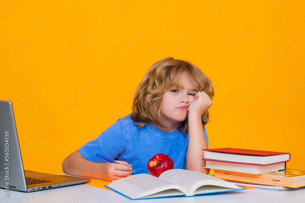 Sad, tired and bored pupil. Portrait of school boy isolated on yellow studio background. Back to school. Funny little child from elementary school with book. Education. Kid study and learning. Sad, tired and bored pupil. Portrait of school boy isolated on yellow studio background. Back to school. Funny little child from elementary school with book. Education. Kid study and learning.