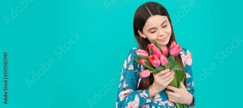 happy child smell tulips. mothers or womens day. kid hold flowers for 8 of march. Banner of spring child girl with tulips flowers bouquet, studio portrait with copy space.