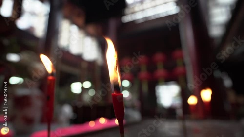 The Interior of a Chinese temple in Kuala Lumpur, focus on foreground Burning candles photo