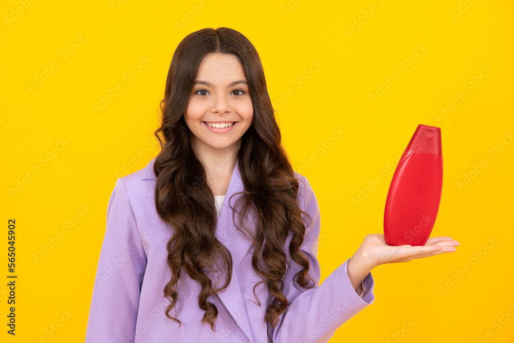 Teenage girl with shampoos conditioners or shower gel. Kids hair care cosmetic product, shampoo bottle. Happy teenager, positive and smiling emotions of teen girl. Teenage girl with shampoos conditioners or shower gel. Kids hair care cosmetic product, shampoo bottle. Happy teenager, positive and smiling emotions of teen girl.