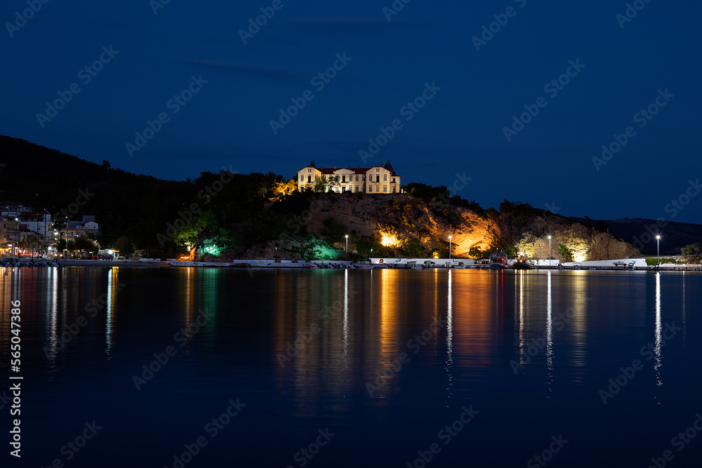 Old buildings lit at night across the Water in Thassos.