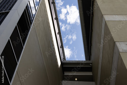 modern office building viewed from below with blue sky above
