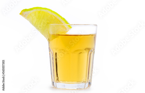 glass of alcoholic drink with lemon, distilled from sugar cane, called in Brazil "pinga" or "cachaça", on isolated white background, Brazillian tipical drink