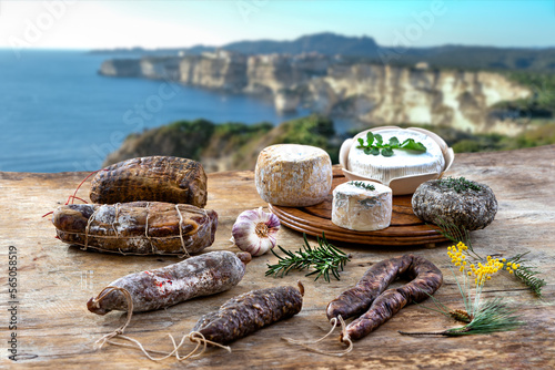 Local wild pork delicatessen, and corsican cheese, sea landscape background