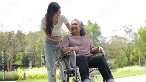 Wallpaper Mural Daughter caring for sick elderly mother sitting in wheelchair The couple was smiling happily in the outdoor garden. Asian family concept. Elderly staff or caregivers Torontodigital.ca