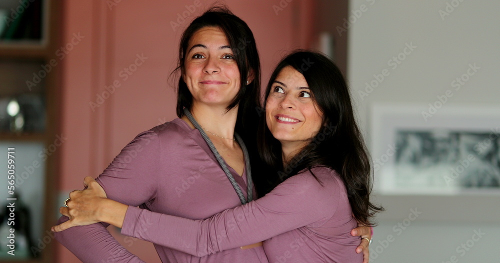 Two adult sisters hugging each other women family love and affection Two adult sisters hugging each other women family love and affection