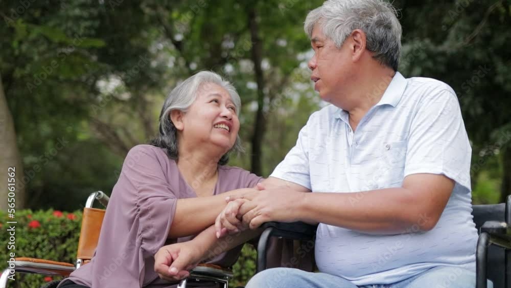 Elderly men and women sitting in wheelchairs in the park. Talk to each other with a happy smile. Elderly couple. Health care in retirement. senior society Elderly men and women sitting in wheelchairs in the park. Talk to each other with a happy smile. Elderly couple. Health care in retirement. senior society