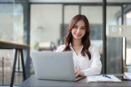 Beautiful Business woman working at home office and analyze financial report document. Accounting and Finance concept