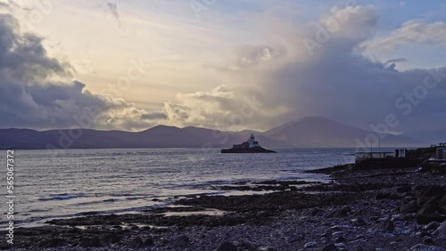 Aerial panorama view of the historic Fenit Lighthouse in Tralee Bay, beautiful clouds, sunset. High quality 4k footage photo