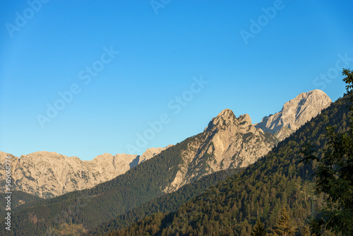 Mountain Range and the peak of the Mount Mangart (2677 m.) seen from the small village of Camporosso in Valcanale, Julian Alps, Tarvisio, Udine, Friuli Venezia Giulia, Italy Slovenia border, Europe. photo