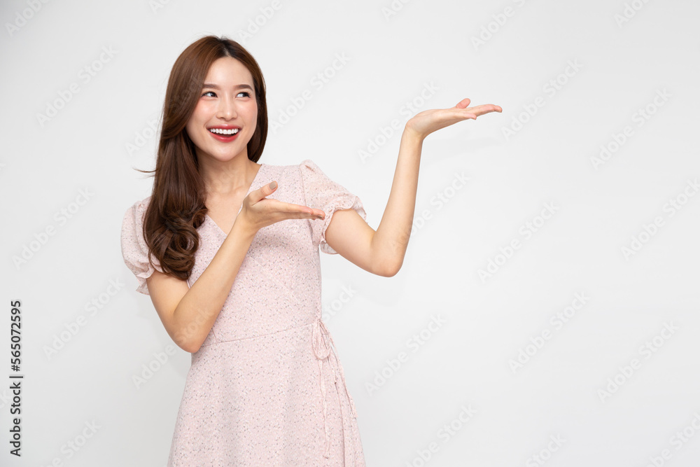 Happy Asian woman presenting or showing open hand palm with copy space for product isolated over white background