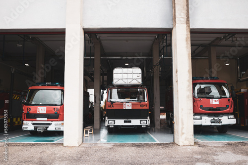 A fire station with parked trucks, fire suppression service.