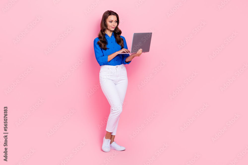 Full body size cadre of confident engineer expert lady wear formal outfit hold netbook keyboard office computer isolated on pink color background Full body size cadre of confident engineer expert lady wear formal outfit hold netbook keyboard office computer isolated on pink color background