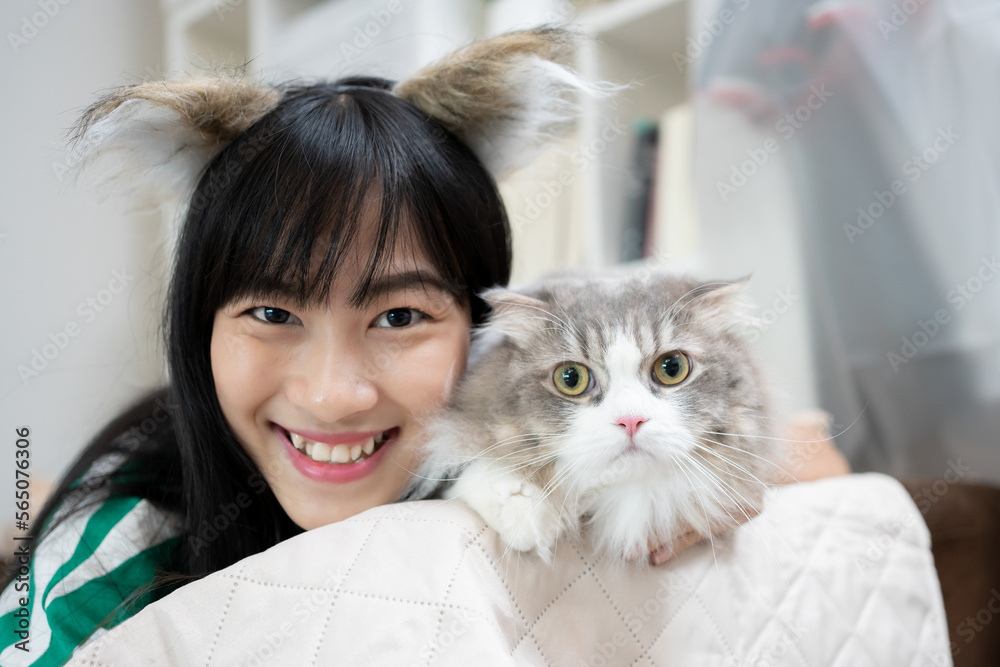 Portrait of young Asian woman smile holding cute siberian cat with green eyes. Female hugging her cute long hair kitty. Background, copy space, close up. Adorable domestic pet concept. Portrait of young Asian woman smile holding cute siberian cat with green eyes. Female hugging her cute long hair kitty. Background, copy space, close up. Adorable domestic pet concept.