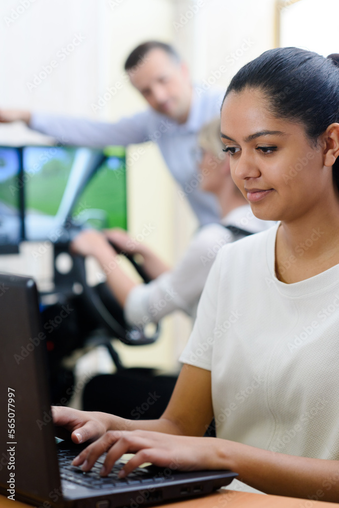 female student doing driving test on computer female student doing driving test on computer