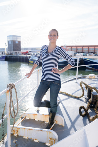 attractive woman standing on a fishing boat © auremar