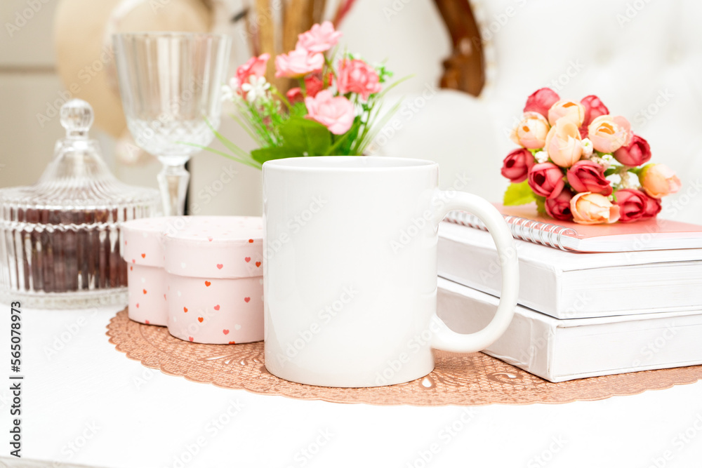 A white blank coffee mug standing out on a rounded mat with some decorations placed around it A white blank coffee mug standing out on a rounded mat with some decorations placed around it
