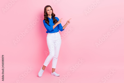 Full body size photo of hr manager lady wear blue shirt pants interested indicate fingers empty space vacancy isolated on pink color background