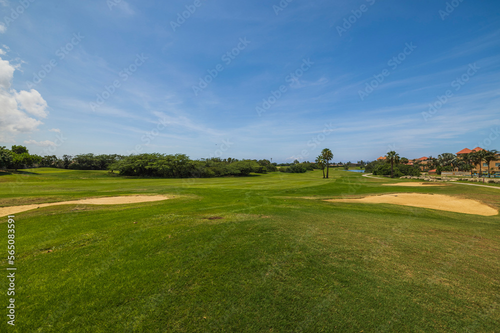 Gorgeous view of green grass golf field on background blue sky. Aruba. Gorgeous view of green grass golf field on background blue sky. Aruba.