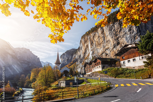 Incredible nature landscape. Sunny autumn view of Lauterbrunnen village with awesome waterfall Staubbach and Swiss Alps in the background. Popular travel destination. Iconik location of Switzerland photo