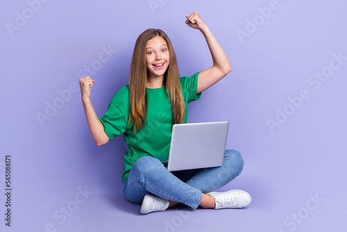 Photo of overjoyed pretty lady sitting floor raise fist hand rejoice passed test exam empty space isolated on purple color background © deagreez