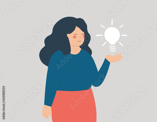 Businesswoman hold a business idea and looks confident of herself. Young entrepreneur female points with her index finger on a light bulb over her. Concept of creativity, innovation, solution, mindset